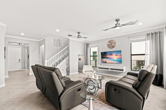 living area with crown molding, stairway, and ceiling fan