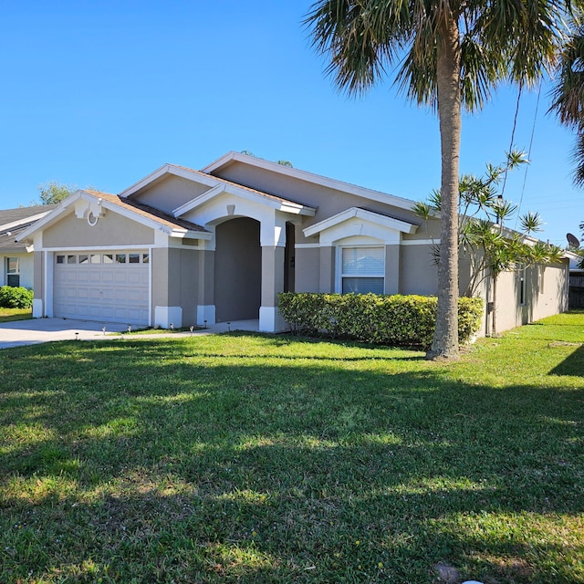 view of front of house with stucco siding, a front yard, concrete driveway, and an attached garage