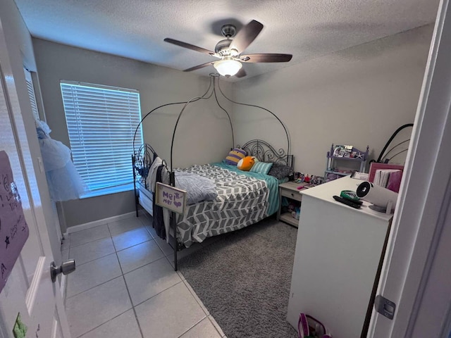 bedroom featuring a textured ceiling, a ceiling fan, and tile patterned flooring