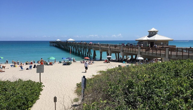 view of water feature featuring a pier and a beach view