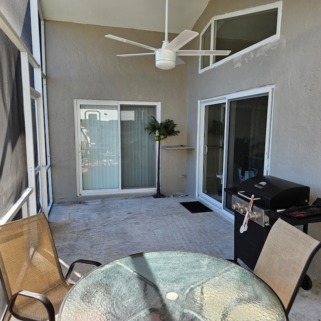 sunroom featuring ceiling fan