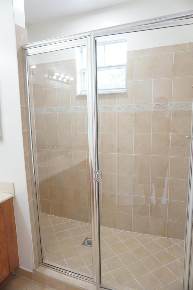 bathroom featuring tile patterned floors, a stall shower, vanity, and french doors