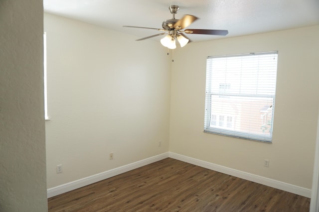 spare room featuring a ceiling fan, baseboards, and wood finished floors