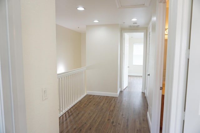 hallway featuring visible vents, wood finished floors, recessed lighting, baseboards, and attic access