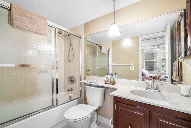 full bath featuring vanity, toilet, and bath / shower combo with glass door