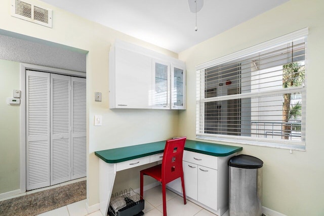 office area with light tile patterned flooring, baseboards, and visible vents