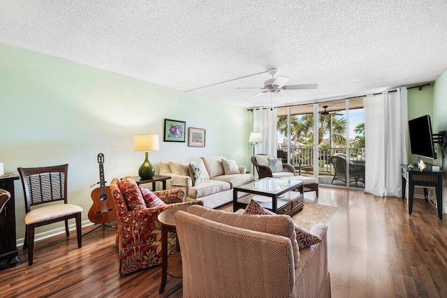 living area with a wall of windows, dark wood-type flooring, a ceiling fan, and a textured ceiling