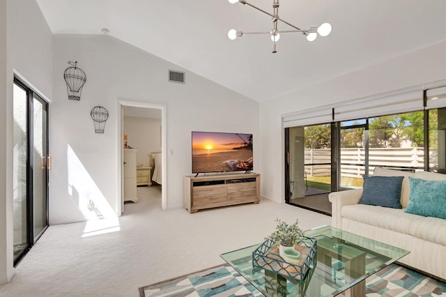 carpeted living area featuring a notable chandelier, visible vents, and high vaulted ceiling