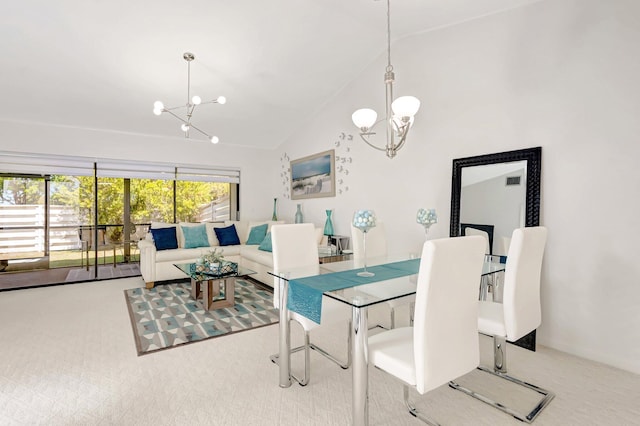 carpeted dining area with a notable chandelier and high vaulted ceiling