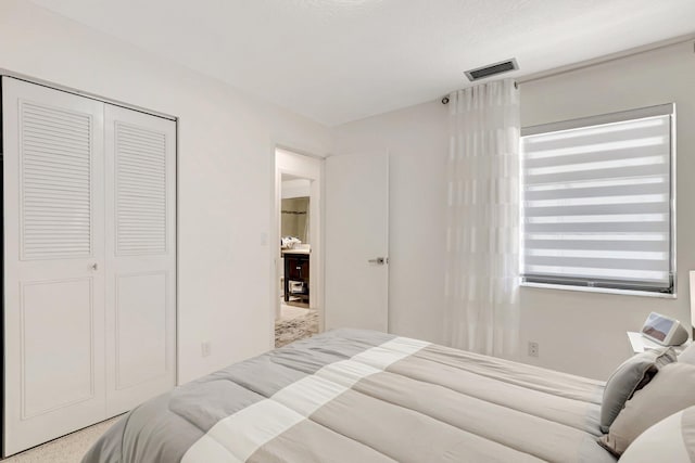 bedroom featuring visible vents and a closet