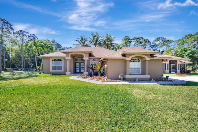 14618 66th St N, Loxahatchee, FL 33470 - mediterranean / spanish-style home featuring stucco siding, a front lawn, and french doors