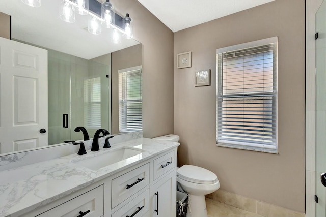 bathroom with tile patterned flooring, a stall shower, toilet, and vanity