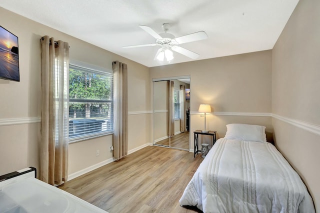 bedroom featuring a closet, baseboards, a ceiling fan, and light wood-style floors