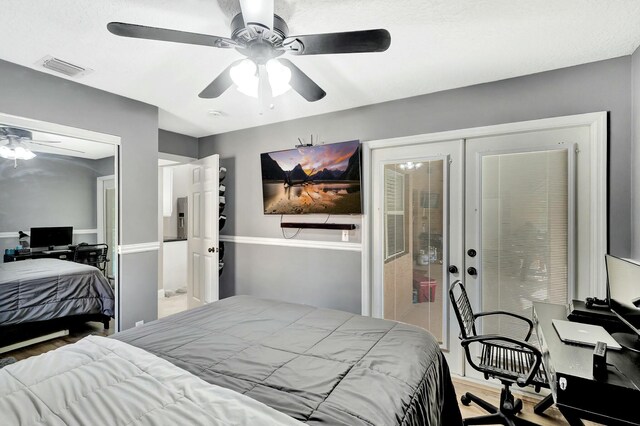 14618 66th St N, Loxahatchee, FL 33470 - bedroom with wood finished floors, visible vents, and a ceiling fan