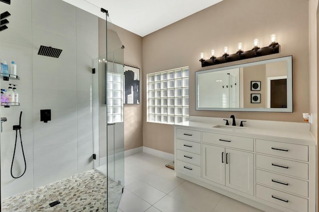 full bathroom with vanity, tile patterned floors, baseboards, and a stall shower