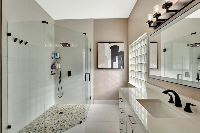 bathroom featuring tile patterned flooring, a stall shower, and vanity