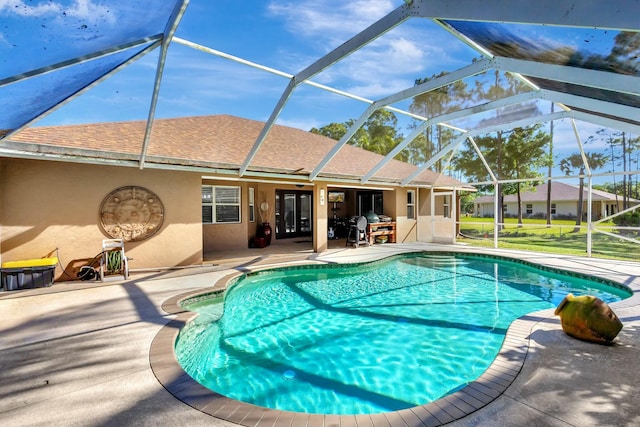 pool with a lanai and a patio area