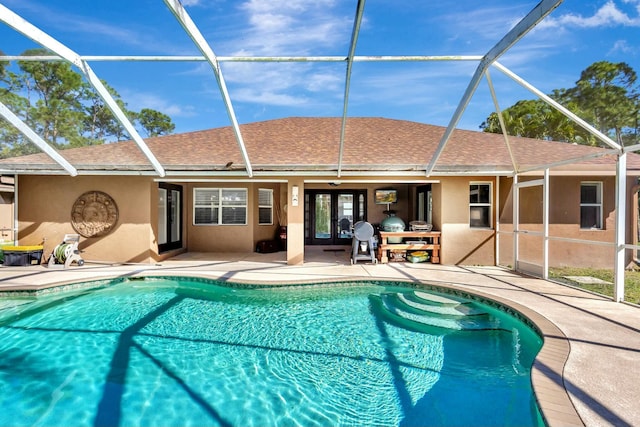 pool with glass enclosure and a patio