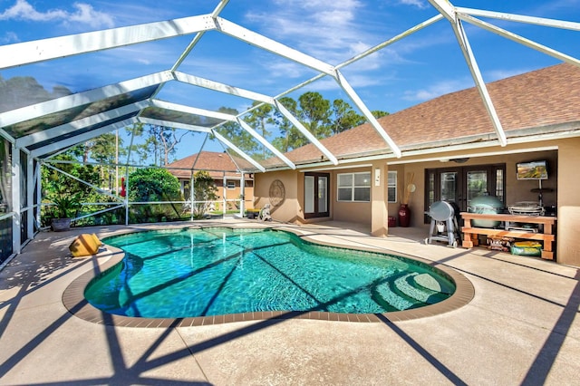 outdoor pool featuring a lanai and a patio area