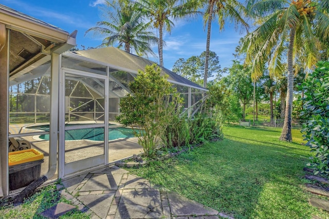 outdoor pool featuring a yard, a patio, a lanai, and fence