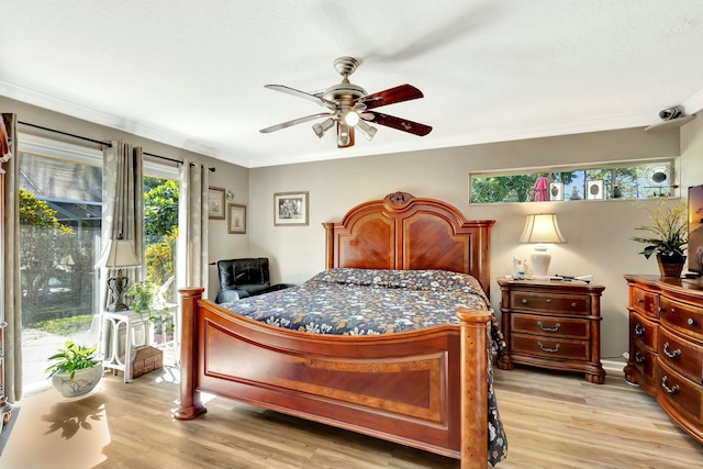 bedroom featuring ceiling fan, light wood-style flooring, and ornamental molding