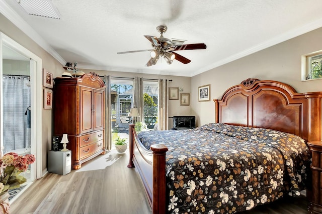 bedroom featuring crown molding, access to outside, wood finished floors, and visible vents