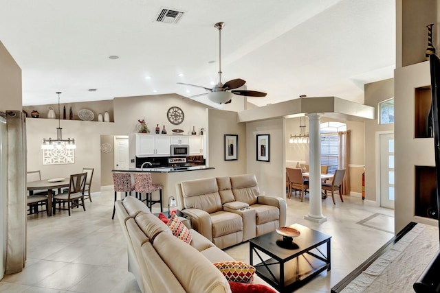14618 66th St N, Loxahatchee, FL 33470 - living area with decorative columns, baseboards, visible vents, lofted ceiling, and ceiling fan with notable chandelier