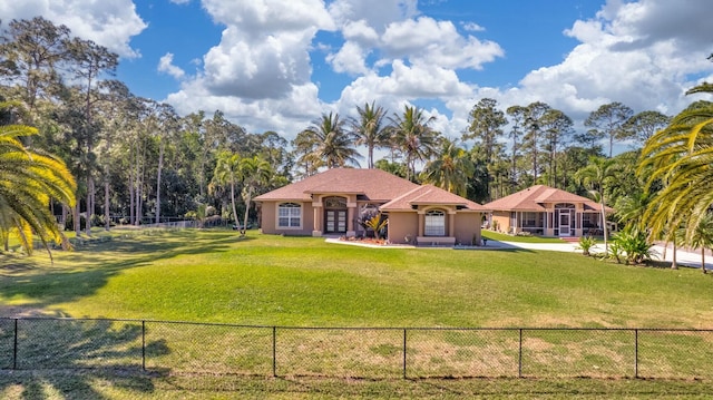 view of front of property with stucco siding, a front lawn, and fence