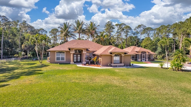 14618 66th St N, Loxahatchee, FL 33470 - view of front of property featuring french doors, a front yard, and stucco siding
