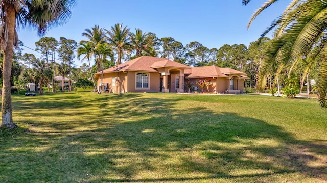 mediterranean / spanish-style home with stucco siding and a front lawn