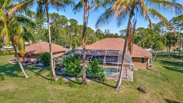 14618 66th St N, Loxahatchee, FL 33470 - back of house featuring a yard, a patio, an outdoor pool, and stucco siding