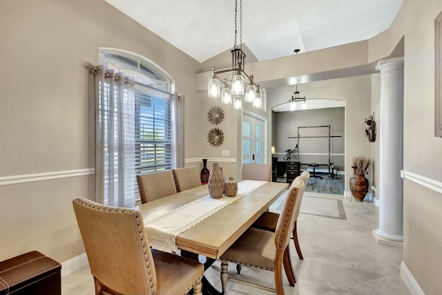 dining space with lofted ceiling, french doors, baseboards, and ornate columns