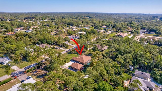 birds eye view of property with a view of trees