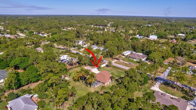 drone / aerial view featuring a wooded view