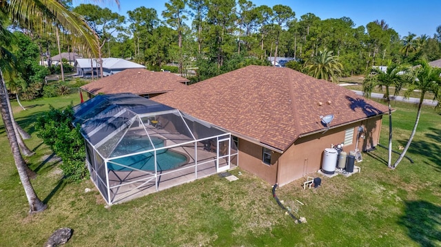 14618 66th St N, Loxahatchee, FL 33470 - rear view of property featuring an outdoor pool, a shingled roof, stucco siding, a patio area, and a lanai