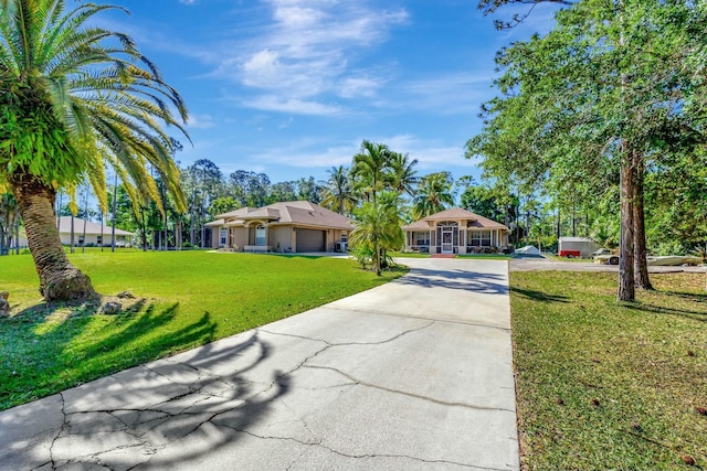 view of front of home with a front lawn, an attached garage, and driveway