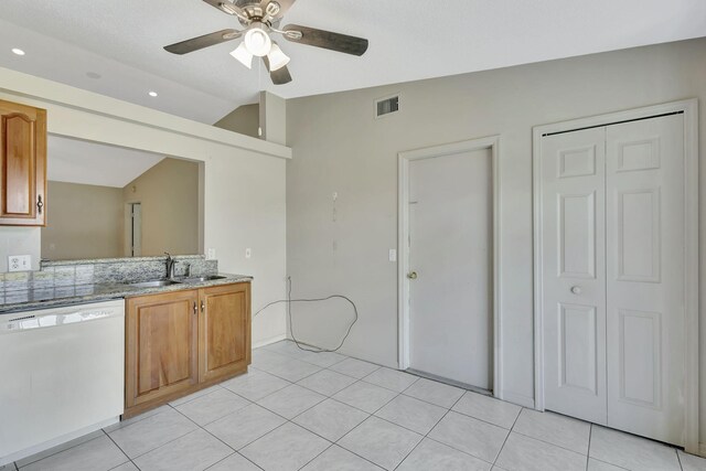 5489 NW Evanston Ave, Port Saint Lucie, FL 34983 - kitchen with dishwasher, lofted ceiling, a sink, a ceiling fan, and brown cabinets