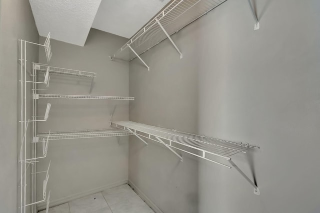 5489 NW Evanston Ave, Port Saint Lucie, FL 34983 - spacious closet featuring tile patterned floors