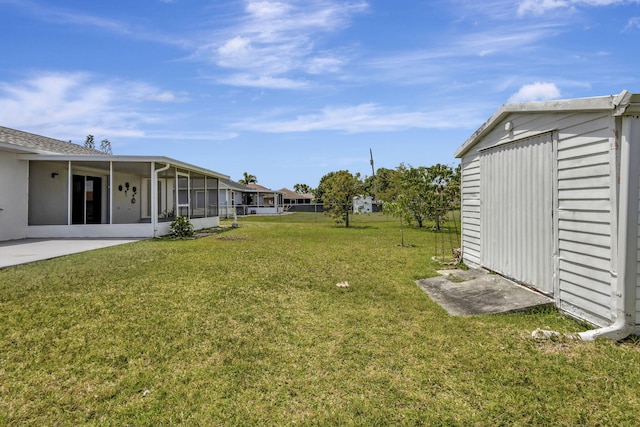 5489 NW Evanston Ave, Port Saint Lucie, FL 34983 - view of green lawn featuring a sunroom and an outdoor structure