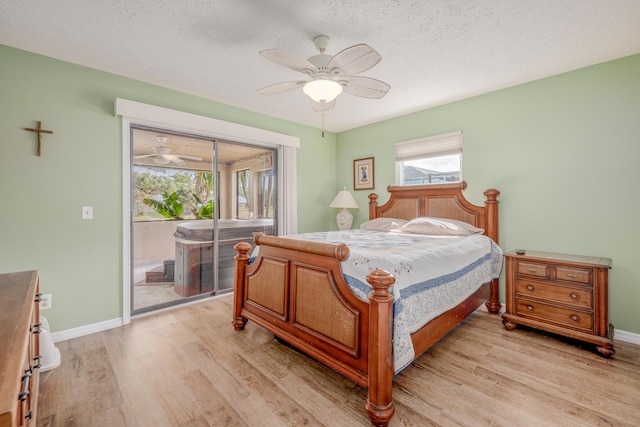 bedroom featuring access to outside, light wood-style flooring, and baseboards