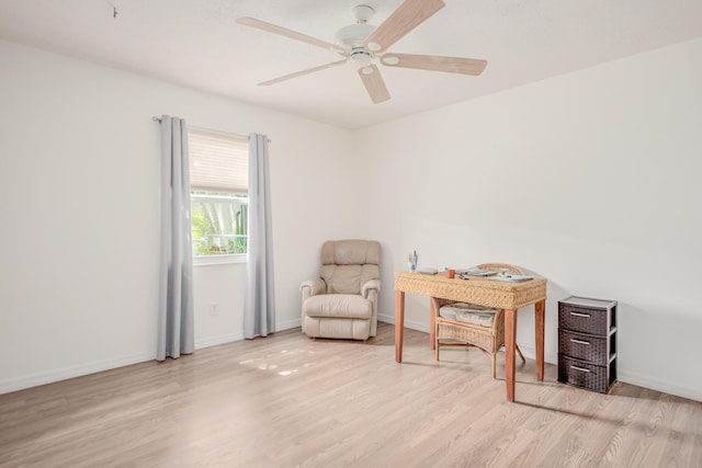 sitting room with a ceiling fan, wood finished floors, and baseboards