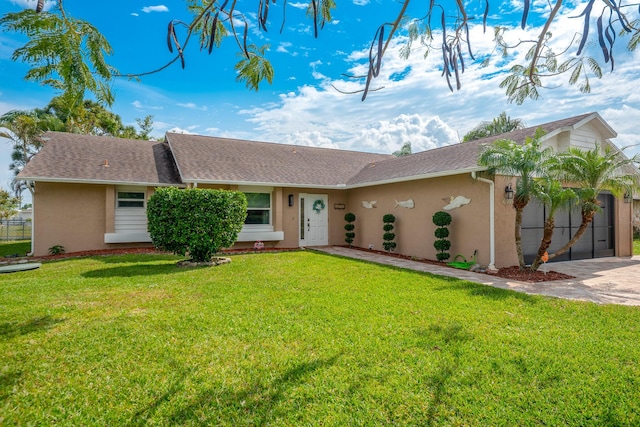 single story home with a front lawn, an attached garage, driveway, and stucco siding