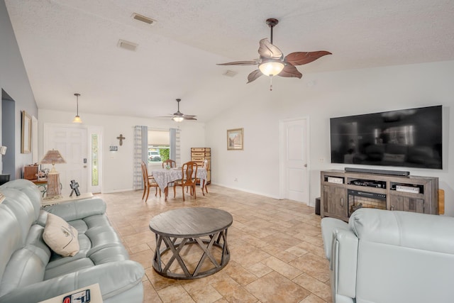 living room featuring baseboards, lofted ceiling, a textured ceiling, and ceiling fan