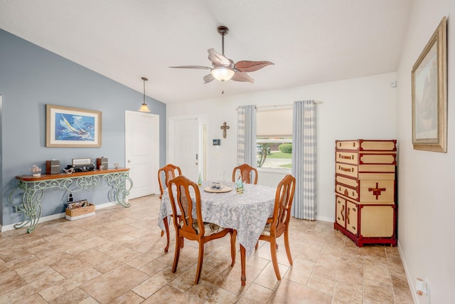 dining space with baseboards, lofted ceiling, and a ceiling fan