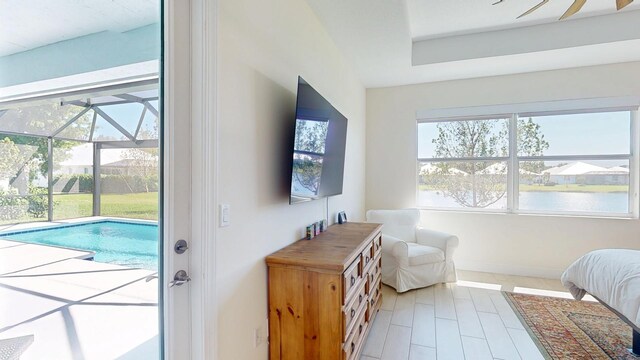 bedroom featuring access to exterior, baseboards, and a sunroom