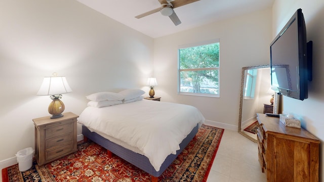 bedroom with ceiling fan, baseboards, and light tile patterned flooring