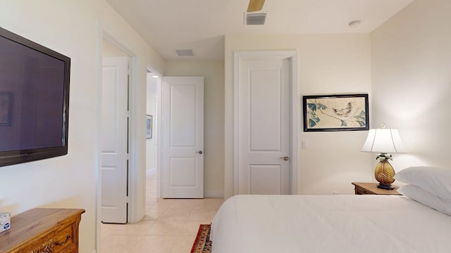 bedroom featuring light tile patterned floors, visible vents, and baseboards