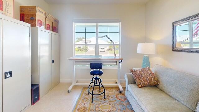 living area with baseboards and tile patterned flooring