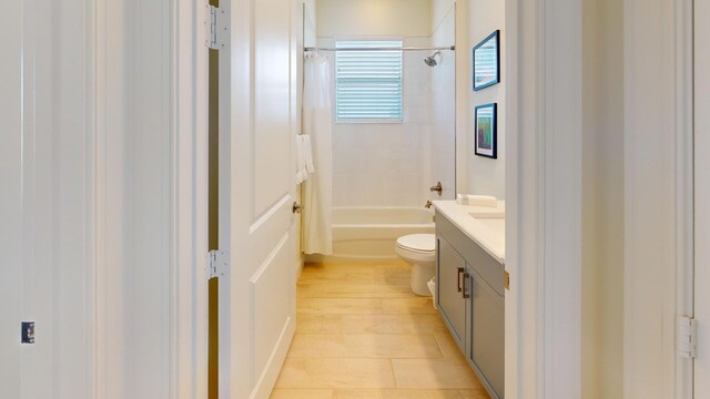 bathroom featuring toilet, shower / bath combo, and vanity