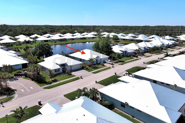 drone / aerial view with a residential view and a water view